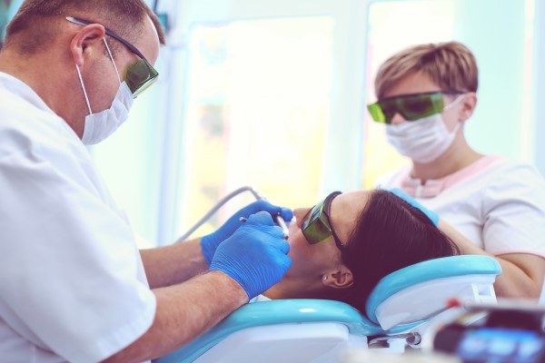 Sedated patient having dental procedures performed