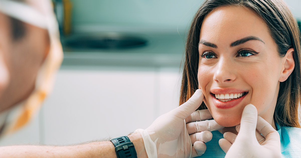 Smiling woman having her teeth examined