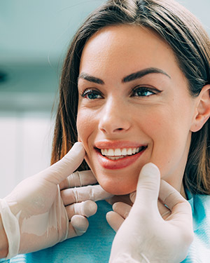 Smiling woman having her teeth examined
